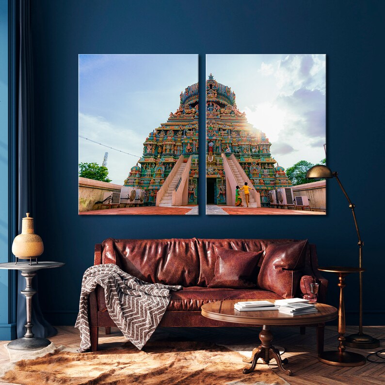 May include: A colorful Hindu temple with a tall, tiered structure and intricate carvings. The temple is decorated with vibrant colors, including blue, green, yellow, and red. The temple is set against a bright blue sky with a few clouds.