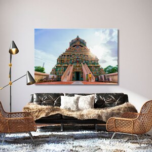 May include: A colorful Hindu temple with a tall, pyramid-shaped structure decorated with intricate carvings and statues. The temple is surrounded by a courtyard and has a large entranceway with two sets of stairs leading up to it.