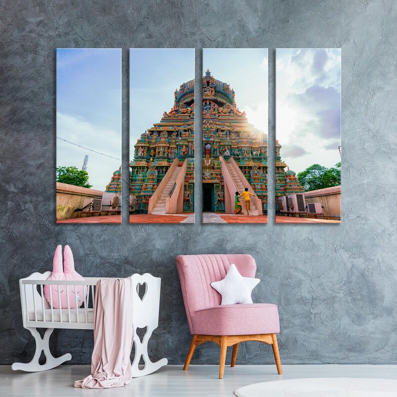 May include: A colorful, multi-tiered Hindu temple with a tall, pointed spire. The temple is decorated with intricate carvings and statues. The temple is set against a blue sky with white clouds.