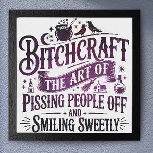 May include: A framed print with the text "Bitchcraft: The Art of Pissing People Off and Smiling Sweetly." The design features a cauldron, birds, and other witchy symbols in purple and white against a white background. The frame is black.
