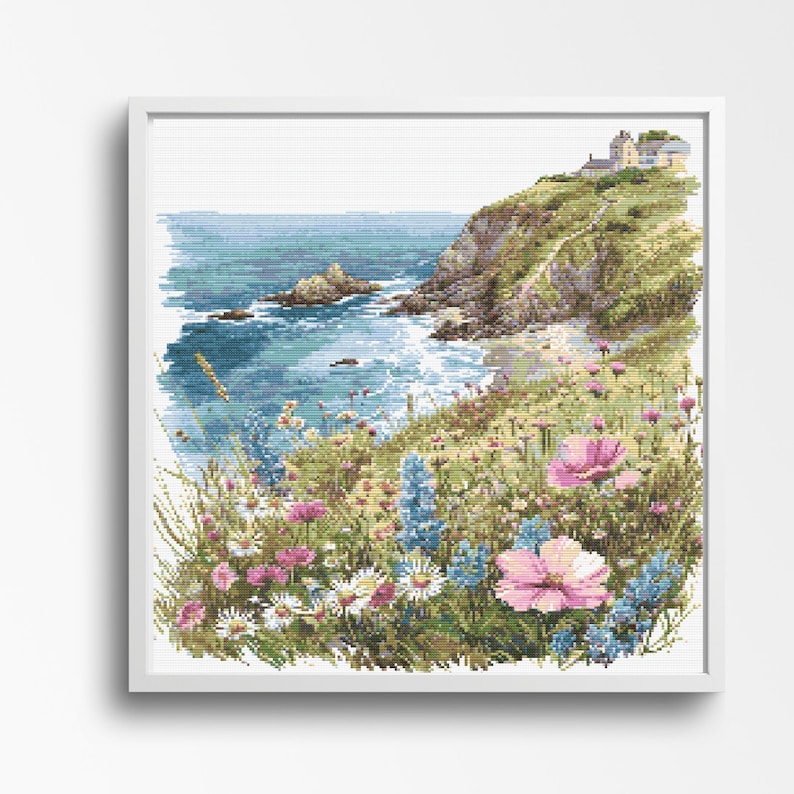 A stunning coastal landscape featuring a rocky cliff adorned with colorful wildflowers. The path leads to a distant cottage overlooking the blue ocean. The scene captures the natural beauty of blooming flowers, rugged coastline, and serene sea.