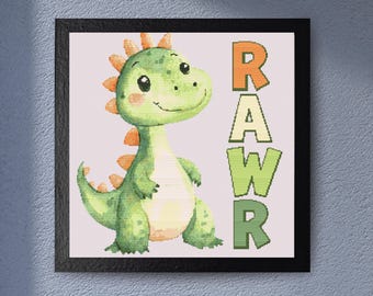 May include: A framed cross-stitch featuring a friendly green dinosaur with orange accents and the word "RAWR" in colorful letters. The dinosaur has a smiling face and is set against a light pink background.