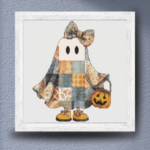 A delightful autumn cross stitch design of  a lovable ghost dressed in a patchwork Halloween costume filled with vintage-inspired quilt patterns and warm seasonal colors. The design combines soft creams, oranges, blues, and greys to create a comforting rustic aesthetic. Carrying a bright jack-o'-lantern bucket and wearing tiny yellow shoes, this character is ideal for Halloween decorating, cozy home decor, handmade seasonal gifts, and relaxing cross stitch projects for autumn enthusiasts.