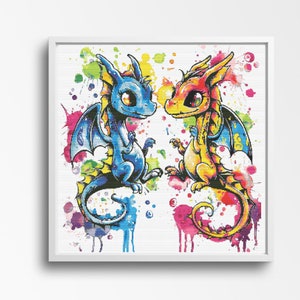 May include: A framed print of two cartoon dragons. One is blue, the other yellow and orange. Both have large eyes and wings. The background features colourful paint splatters in shades of pink, blue, yellow, and green.