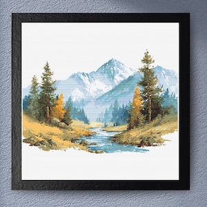 May include: A framed cross-stitch landscape depicting a mountain range with snow-covered peaks, a river, and evergreen and yellow trees. The artwork is in a black frame, creating a tranquil, natural scene.