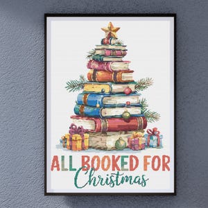 May include: A framed print features a Christmas tree made of colorful books, adorned with ornaments and a star. The phrase "ALL BOOKED FOR Christmas" is written below in green and orange. Presents are at the base of the tree.
