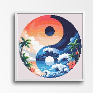 May include: A framed cross-stitch artwork depicting a Yin and Yang symbol with a tropical beach scene. The top half features a sunset with palm trees, while the bottom half shows ocean waves. The artwork is framed in a white square frame.