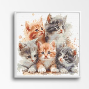 May include: A framed watercolour-style artwork depicting five cute kittens. The kittens have ginger, grey, and white fur, with expressive eyes. The artwork has a soft, painterly quality, with subtle watercolour splashes in the background.