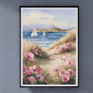 May include: Framed artwork showing a coastal scene with sailboats on blue water. A path leads through pink flowers and tall grass towards the sea. A lighthouse sits on a distant island under a light blue sky.