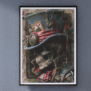 May include: Framed artwork featuring a skull wearing a top hat with a playing card tucked inside. The hat is blue and red, and the skull is set against a vintage playing card background. The artwork has a dark, gothic theme.