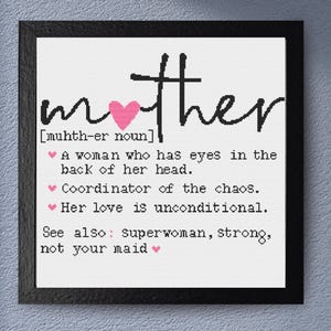 May include: A framed print with the word "mother" in black script, a pink heart, and a definition. The definition includes phrases like "eyes in the back of her head" and "coordinator of the chaos."