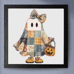 This cute Halloween ghost cross stitch pattern captures the magic of autumn. A playful ghost wrapped in a colorful patchwork costume. Detailed fabric-style blocks in orange, cream, blue, and grey create a cozy handcrafted appearance, while the oversized bow and pumpkin bucket add festive charm. Designed for lovers of cottagecore style, Halloween decorations and seasonal embroidery,  this pattern offers a heartwarming stitching experience and beautiful finished display piece.