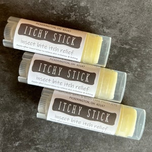 May include: Three white tubes with yellow balm inside. Each tube has a black label with the text "ITCHY STICK insect bite itch relief" and the location "PICKERINGTON, OH 43147".
