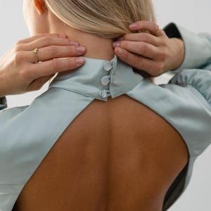 Close up view on the back part of the dress with button closure