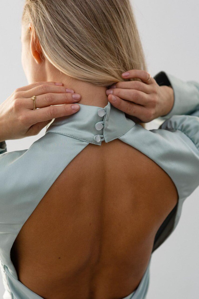 Close up view on the back part of the dress with button closure