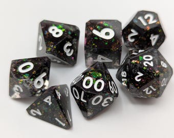 Sparkly confetti dungeons and dragons TTRPG dice set with bright white inked numbers.
