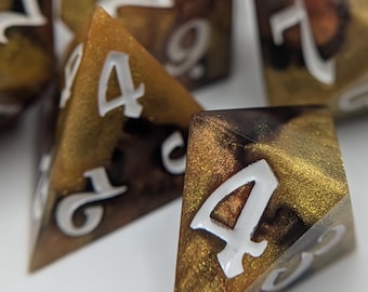 Black and gold calico cat inspired dice with bright white inked numbers
