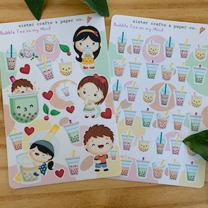May include: Two sticker sheets with bubble tea designs and cartoon characters. The stickers show bubble tea cups, hearts, and the text "Bubble Tea on my Mind" and "sister crafts & paper co."