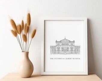 May include: A white framed print featuring a black and white line drawing of the Victoria & Albert Museum in London. The text "THE VICTORIA & ALBERT MUSEUM" is printed below the drawing.