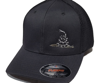 May include: A black and grey Flexfit baseball cap with a black mesh back. The cap features an embroidered image of a coiled snake with a 'Don't Tread On Me' inscription. The Flexfit logo is visible on the underside of the bill.