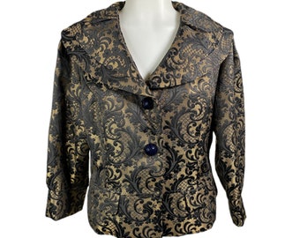 May include: A black and gold patterned blazer with three-quarter sleeves. The jacket features a notched collar, two front pockets, and three navy blue buttons. The fabric has a floral design.