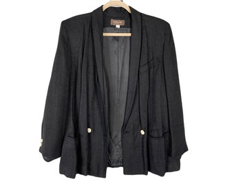 May include: A black double-breasted blazer with a long, pointed collar and two gold buttons. The blazer has a smooth, textured fabric and a relaxed fit.