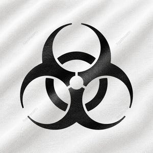 May include: A black biohazard symbol printed on a white fabric background. The fabric has a visible woven texture with subtle folds and creases. The iconic three-lobed hazard warning sign is centred, featuring sharp, curved edges and a central circle.