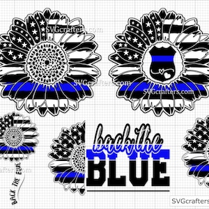 May include: Black and white sunflower design with a blue line in the center. The sunflower has a police badge in the center. The text "back the blue" is written below the sunflower.