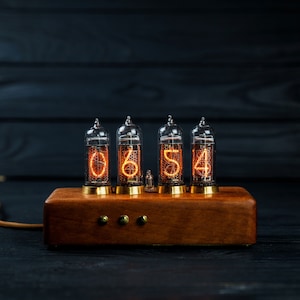 Nixie tube clock  (IN-14 tubes), made of eucalyptus and brass .