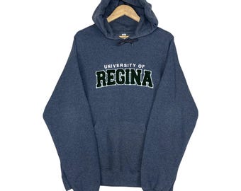 ¡Elige! Sudadera con capucha de la Universidad de Regina con logo estampado, talla grande.