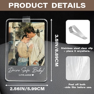 May include: A rectangular clear acrylic car visor clip featuring a custom photo of a couple, with the printed text Drive Safe. Baby! LOVE.ANNE. The product measures 3.5 inches by 2.56 inches and includes a separate stainless steel visor clip attachment.