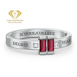 May include: A silver class ring with two red gemstones and two small diamonds. The ring is engraved with the words "SCHOOL/COLLEGE", "DEGREE", and "YEAR".