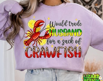 May include: A purple sweatshirt with a crawfish and lemons graphic. The text on the shirt reads "Would trade HUSBAND for a sack of CRAWFISH".