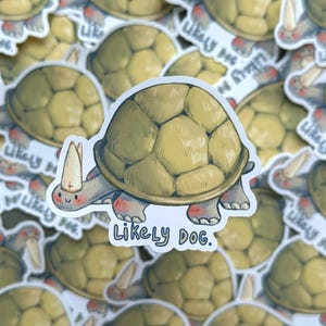 Puede incluir: Una pegatina con una tortuga de dibujos animados que lleva una mitra de obispo y una expresión feliz. La tortuga camina y el texto "Likely Dog." está debajo.