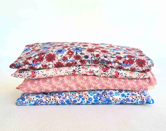 Small dry hot water bottle with removable cover with wheat grains, cherry pits or flax seeds