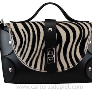Black leather bag with shoulder strap and handle-flap made of zebra pony skin