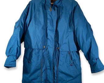 May include: A blue long-sleeved jacket with a zipper closure and a drawstring waist. The jacket has two pockets on the front and a hood.