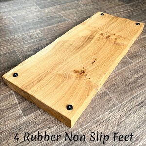 May include: A rectangular, light-coloured wooden shelf with visible wood grain. The shelf has four black rubber non-slip feet. The text "4 Rubber Non Slip Feet" is printed at the bottom of the image.