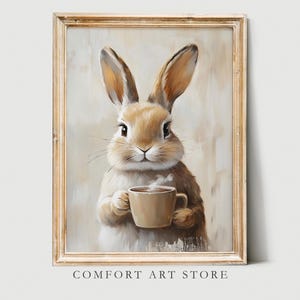May include: A painting of a brown rabbit holding a cup of coffee. The rabbit is looking directly at the viewer. The background is a light brown color.