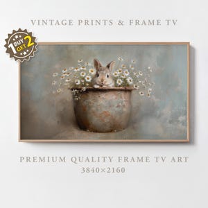 May include: A framed print featuring a rabbit peeking out of a rustic metal pot filled with daisies. The artwork has a vintage aesthetic with soft colors and the text "VINTAGE PRINTS & FRAME TV" at the top. The bottom text reads "PREMIUM QUALITY FRAME TV ART 3840x2160".
