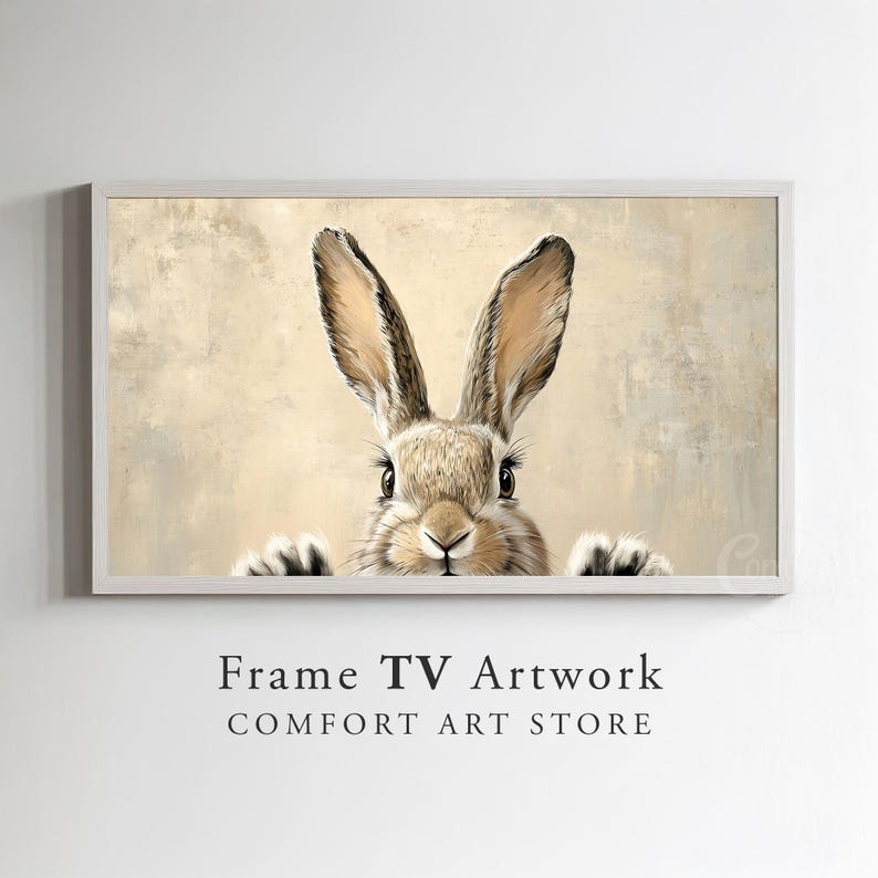 May include: A close-up of a brown rabbit with long ears peeking out from behind a textured beige background. The rabbit has a white nose and black eyes.