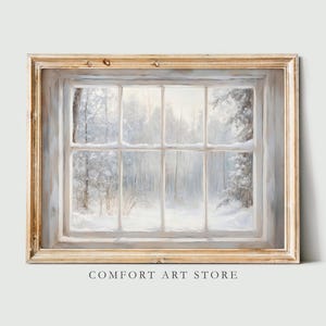 May include: A framed print of a winter landscape viewed through a window. The artwork depicts a snowy forest scene in shades of white, gray, and light blue. The frame is a distressed gold color. The text "COMFORT ART STORE" is at the bottom.