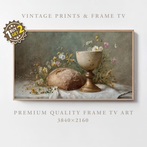 May include: A framed vintage print featuring a still life with a loaf of bread, a chalice, and wildflowers. The artwork has a muted color palette with a focus on natural elements. The frame is a light wood color.