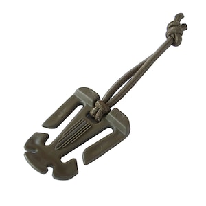 May include: A tan plastic clip with a loop of tan cord attached. The clip has a textured surface and a small hole on each side.