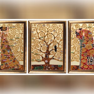 May include: A triptych of framed art prints featuring gold and jewel-toned figures and a tree against a swirling gold background. The artwork is reminiscent of Gustav Klimt's style, with intricate patterns and textures.