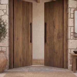 May include: A pair of tall, double wooden doors with a natural brown wood grain finish and long, vertical black metal handles. The doors are set within a light-colored stone archway, featuring a textured surface and a visible wood plank construction.