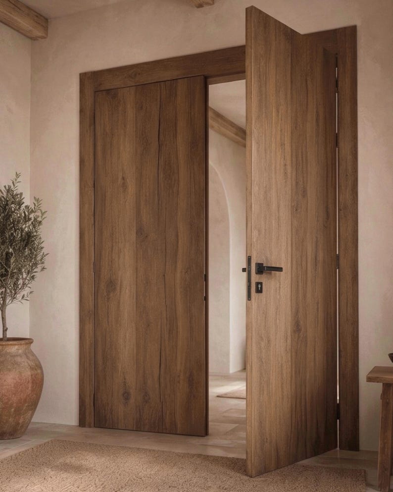 May include: A set of interior doors featuring a medium brown wood grain finish with visible vertical textures. The doors are installed within a matching wooden frame, with one door slightly ajar, revealing a black metal handle and a keyhole plate.