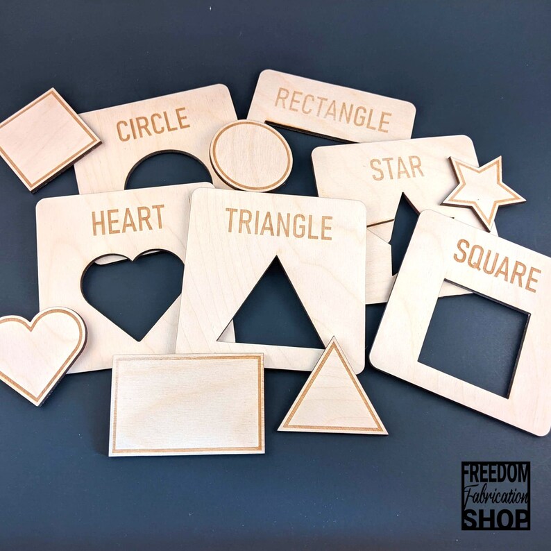 May include: Wooden shapes with cutouts for a shape sorting activity. The shapes include a circle, square, rectangle, triangle, star, and heart. The shapes are labeled with their names.