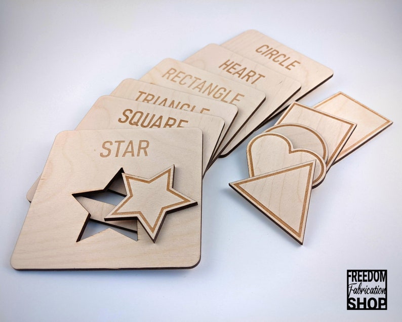 May include: Wooden puzzle pieces with different shapes, including a circle, heart, rectangle, triangle, square, and star. Each piece has the name of the shape written on it.