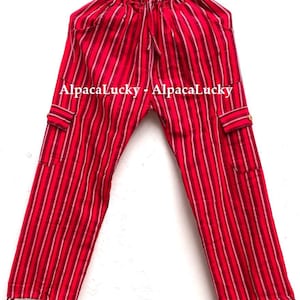 May include: Red and white striped pants with pockets and a drawstring waist. The pants have a relaxed fit and are made of a lightweight fabric. The text "AlpacaLucky - AlpacaLucky" is printed on the pants.
